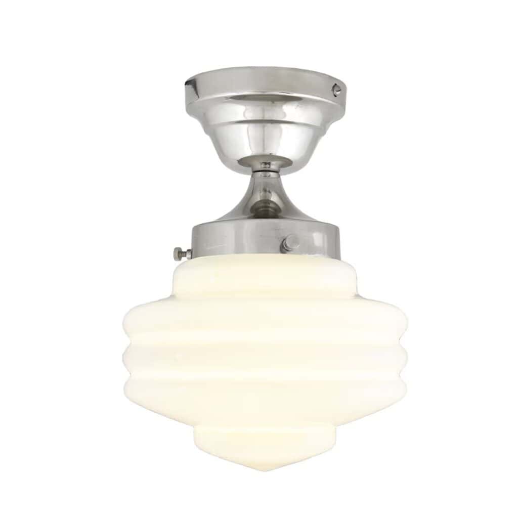 Taklampa VALTER från Strömshaga med tänd ljuskälla som lyser genom den opalvita glaskupan och förnicklad bas i klassisk design.