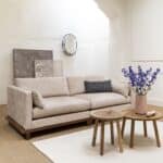 Japandi-soffa i sandfärgat tyg med träsockel i valnöt – Zuiver Blossom 3-sits i ljust vardagsrum.