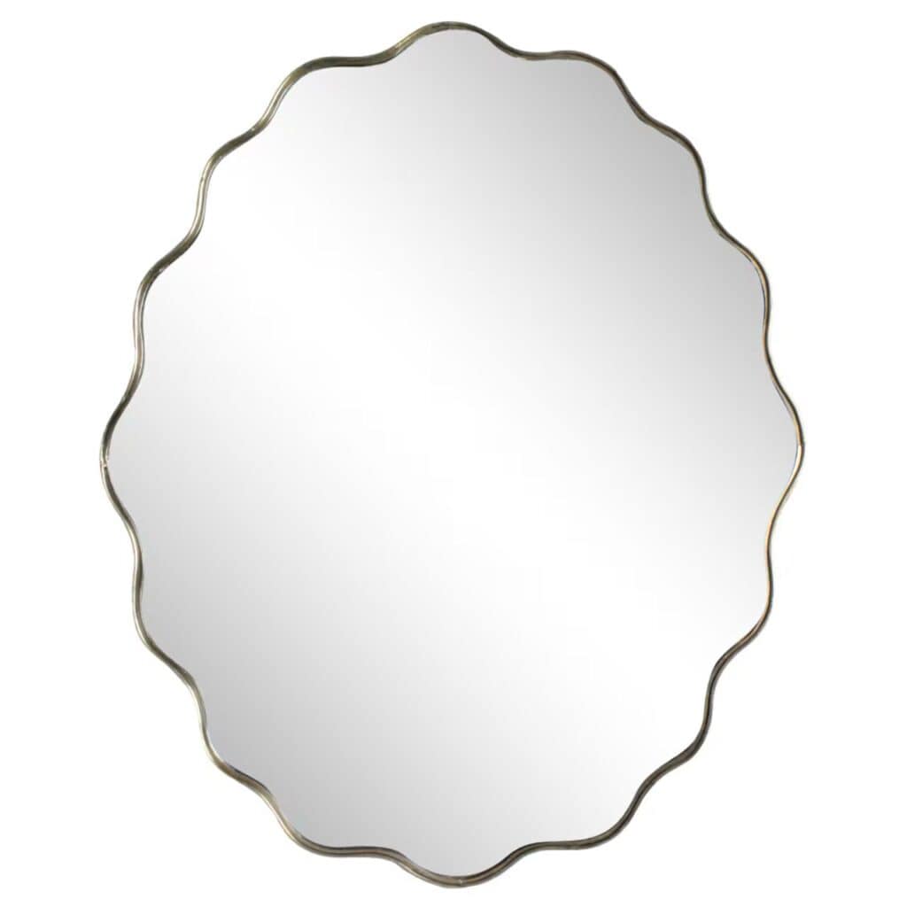 Oval väggspegel med vågig kant i antik mässing, modell Jonna från Strömshaga, storlek 68 x 55 cm.