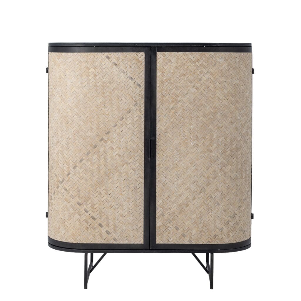 Skänk i svart metall och rotting från Bloomingville med rundade former och flätade dörrar i bambu. Modell Ember, hos Hemlängtan.