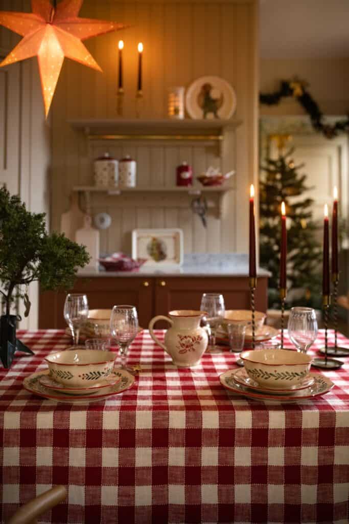 Lantlig juldukning med rödvitrutig duk, mässingsljusstakar och klassiskt porslin – julinspiration från Hemlängtan.