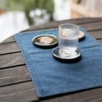 Bordstablett Deni i denim med glas och fat på dukat bord